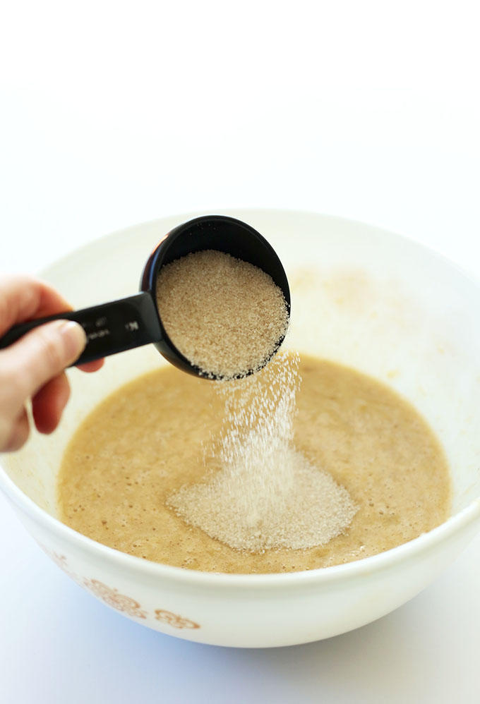 Pouring sugar into a bowl for our 1-bowl gluten free banana bread recipe