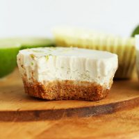 Half eaten Mini Vegan Key Lime Pie on a cutting board