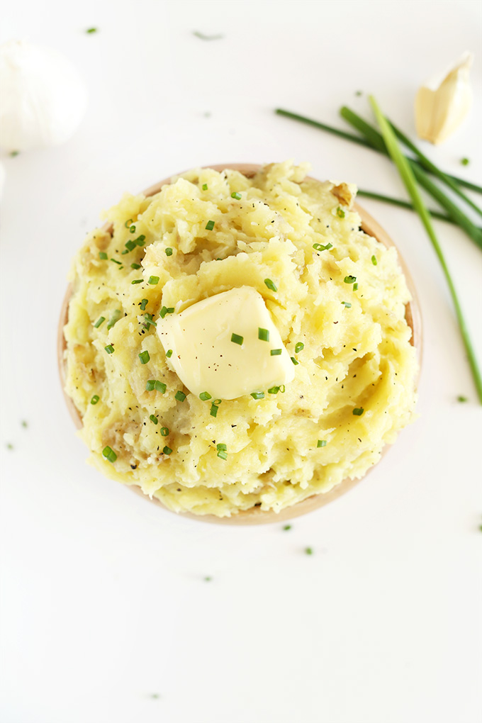 Bowl of dairy-free mashers topped with vegan butter and fresh chives