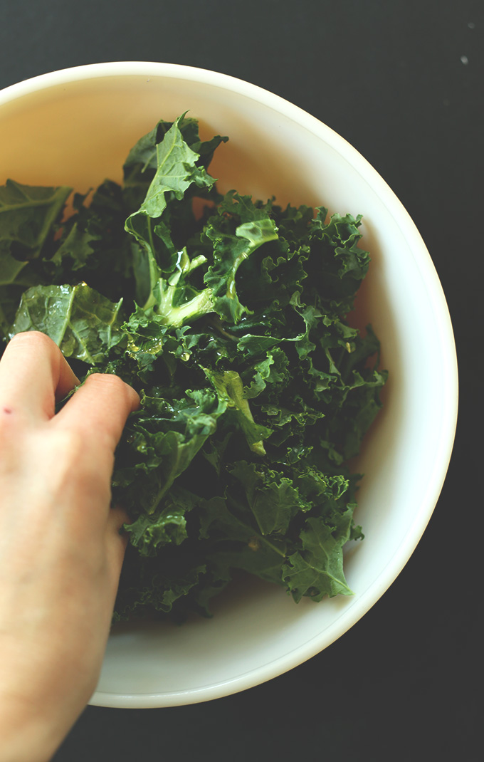 Massaging kale leaves for a delicious vegan salad