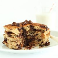 Stack of Chocolate Chip Oatmeal Cookie Pancakes with a slice removed