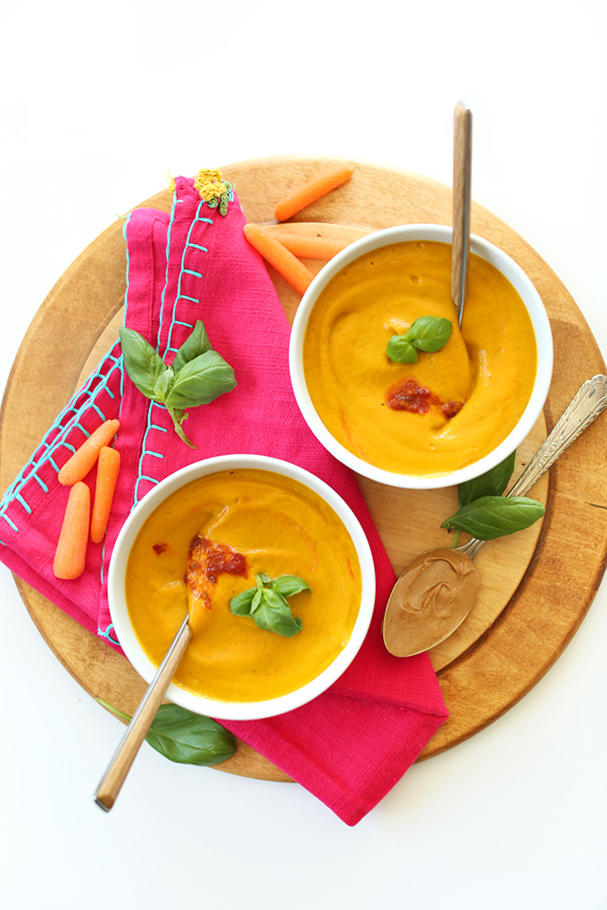 Bowls of Carrot Soup with Peanut Butter and Chili Sauce