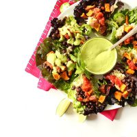 Bowl of dressing surrounded by Mexican Quinoa Salad Cups