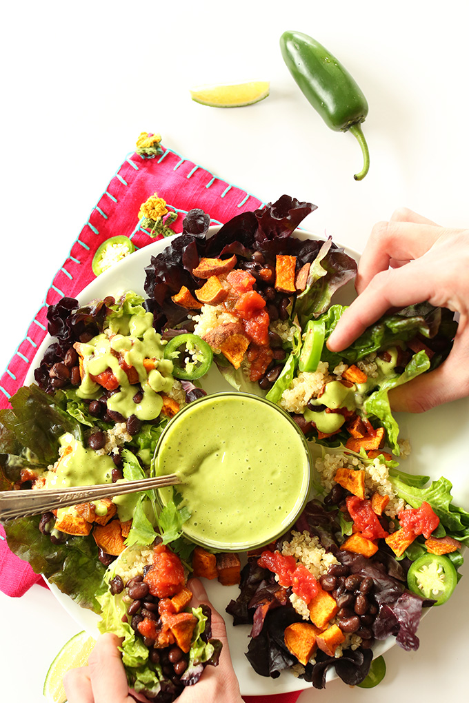 Grabbing a Mexican Quinoa Salad Cup made with sweet potatoes and black beans