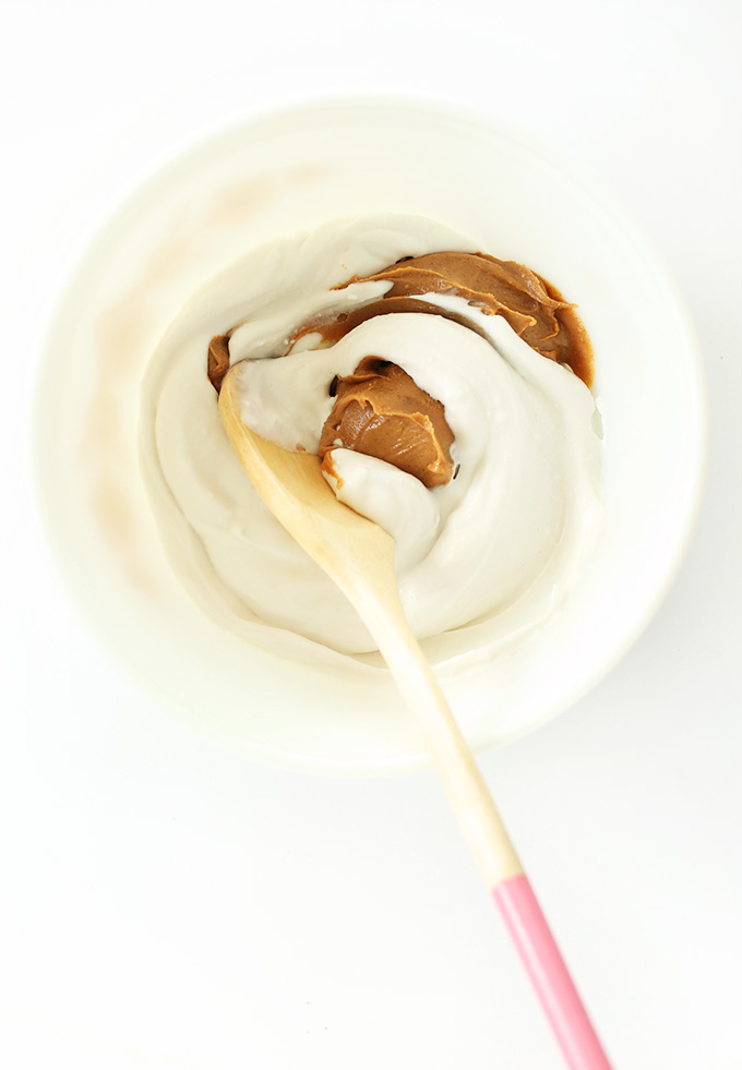 Mixing together coconut whipped cream and peanut butter for vegan PB Mousse Cups