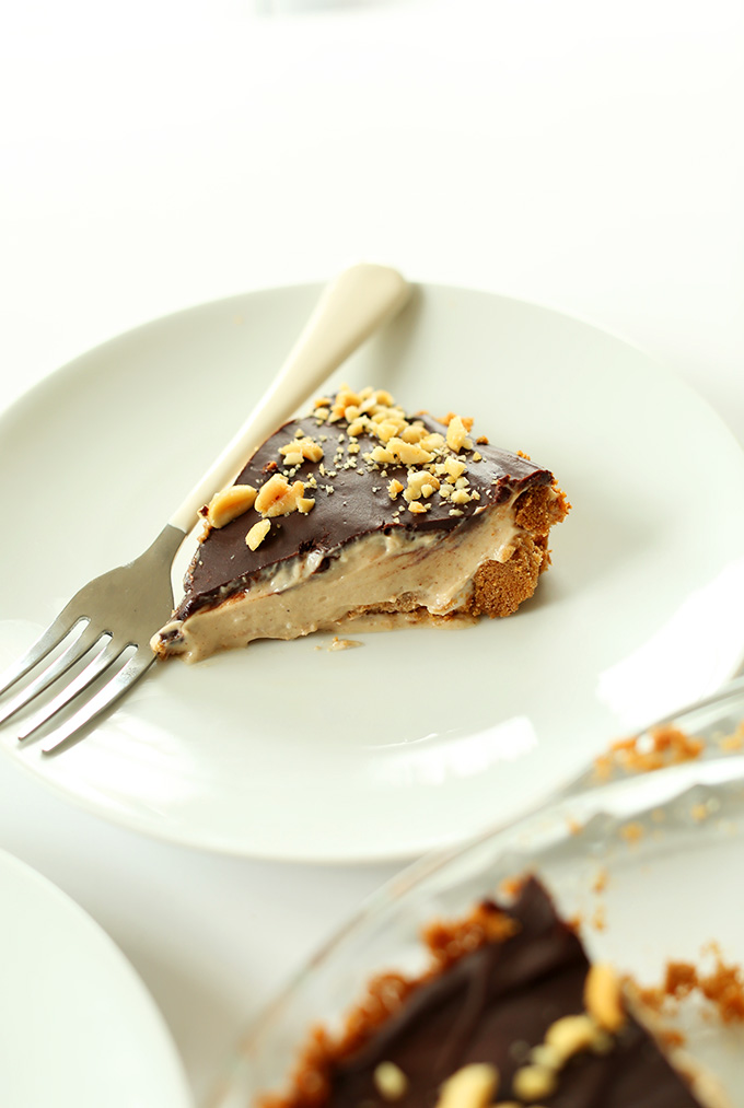 Slice of Peanut Butter Cup Pie with a mousse filling, graham cracker crust, and ganache top