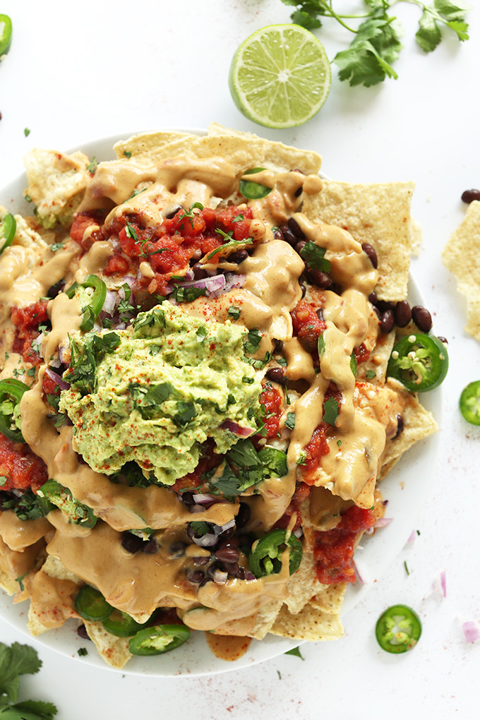 Big plate of Vegan Nachos made with cashew-less vegan queso and guacamole