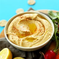 Bowl of homemade hummus topped with olive oil and paprika
