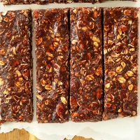 Parchment-lined cutting board with a batch of Healthy Brownie Granola Bars