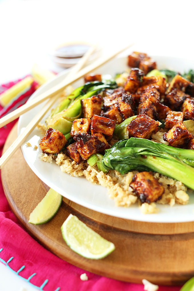 Plate of cauliflower rice and bok choy topped with Easy Crispy Baked Tofu