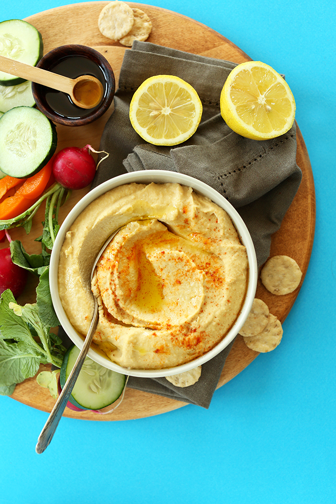 Veggies and bowl of creamy restaurant-quality hummus topped with paprika
