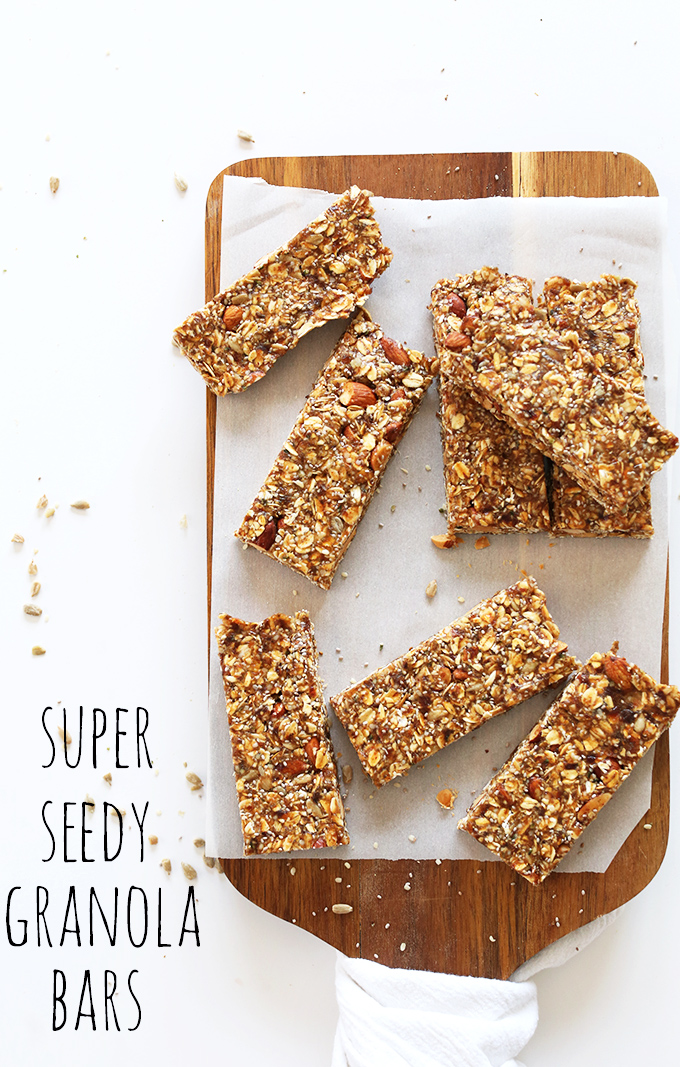 Super Seedy Granola Bars resting on a parchment-topped cutting board