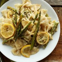 Plate of Vegan Asparagus Pasta topped with cooked lemon slices