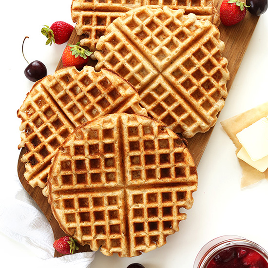 Homemade Freezer Waffles on a cutting board with fresh fruit