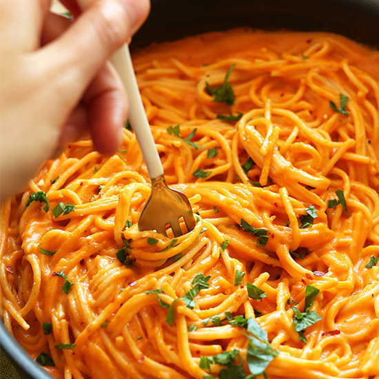 Using a fork to swirl a bite of Vegan Roasted Red Pepper Pasta