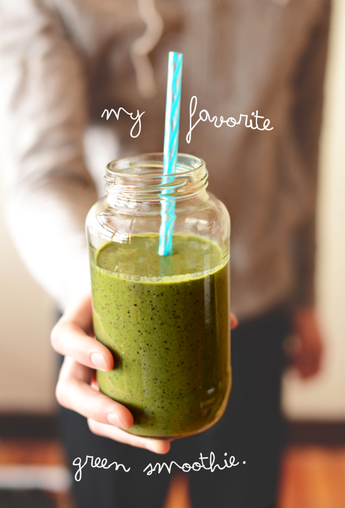 Holding a glass of our favorite Green Smoothie Recipe
