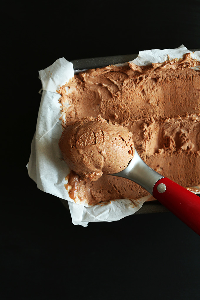 Scooping up No-Churn Vegan Chocolate Ice Cream for homemade banana splits