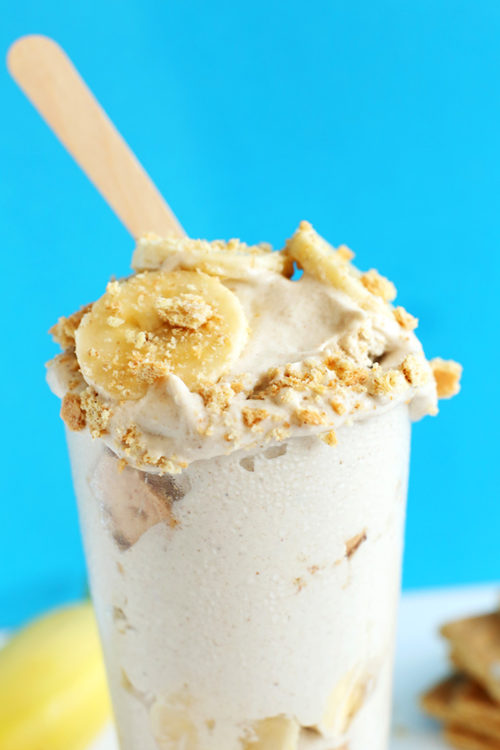 Glass of homemade Vegan Banana Cream Pie Blizzard with a wooden popsicle stick coming out