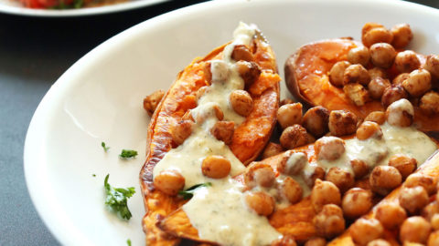 Drizzling dressing onto Mediterranean Baked Sweet Potatoes