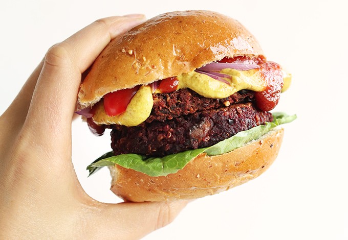 Holding up a healthy Black Bean Beet Burger