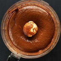Food processor with freshly blended vegan Chocolate Avocado Pudding