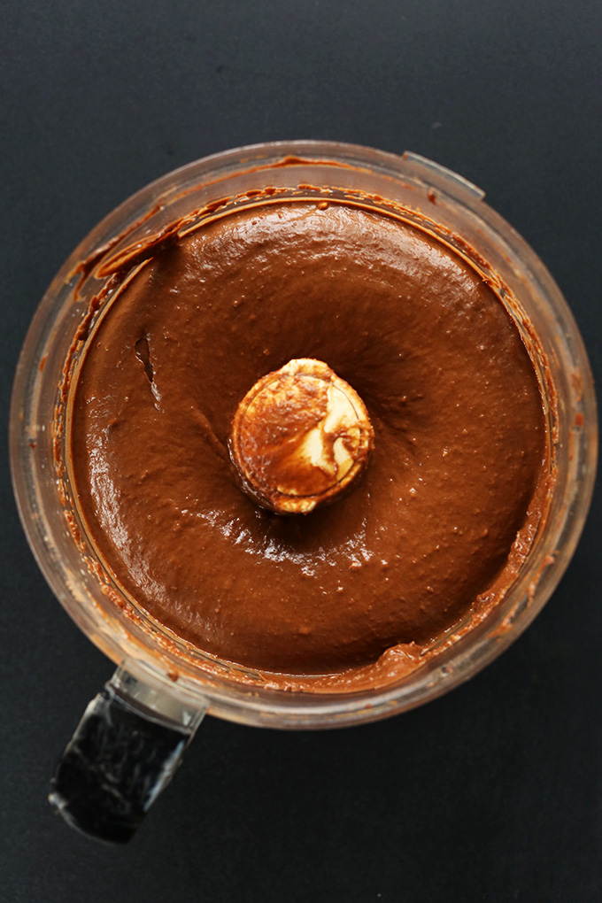 Food processor with freshly blended vegan Chocolate Avocado Pudding