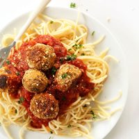 Plate of spaghetti noodles topped with marinara and Tempeh Meatballs