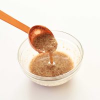 Flax egg dripping off a spoon into a bowl