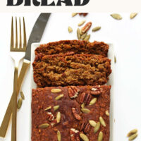 Partially sliced loaf of our vegan and gluten-free 1-bowl pumpkin bread