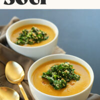 Two bowls of our simple, 8-ingredient, vegan pumpkin soup with a garlic kale sesame topping