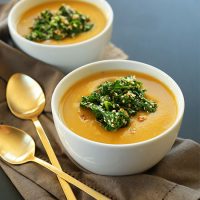 Bowls of our Simple Pumpkin Soup recipe with a Sesame Kale Topping