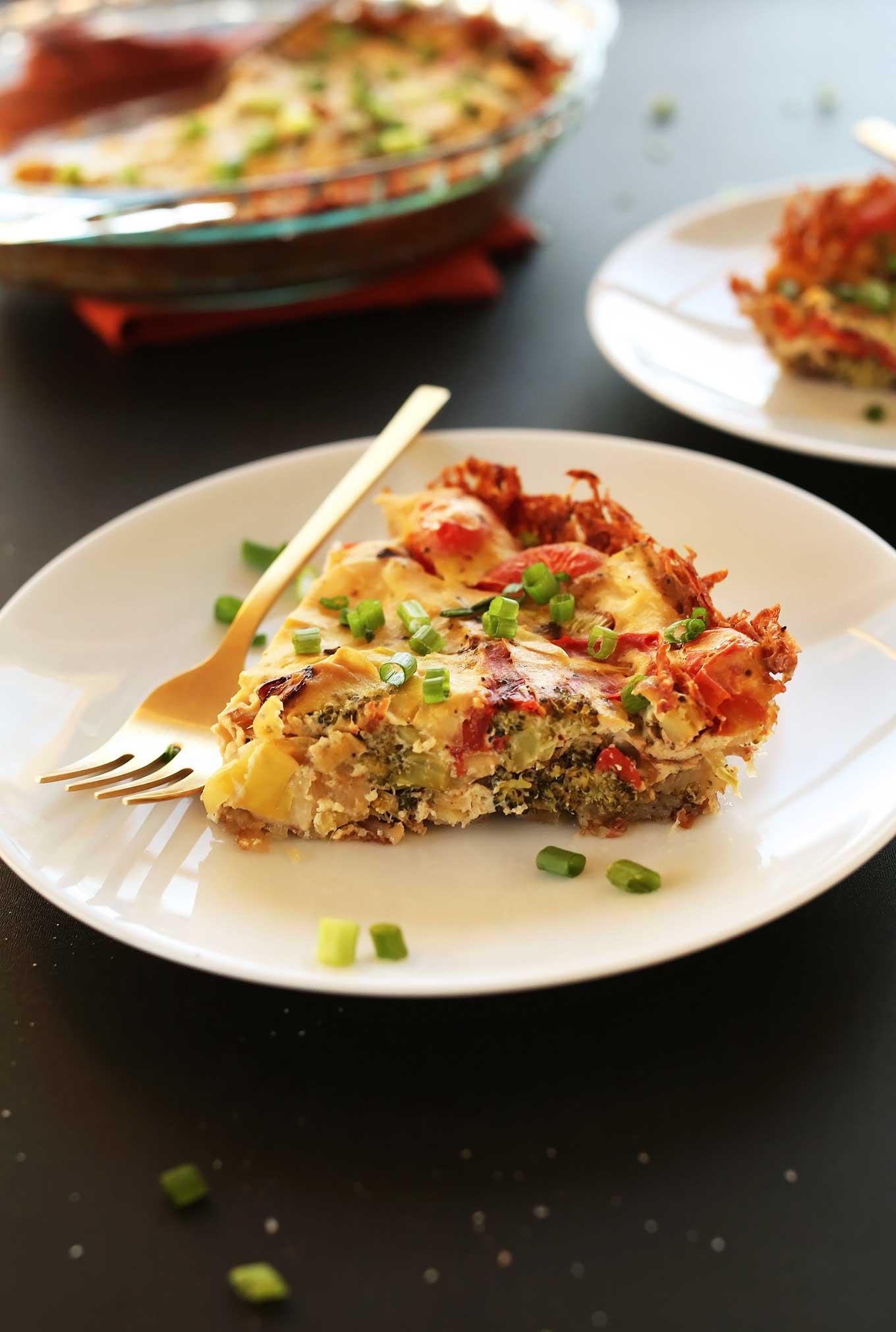 Slice of our gluten-free egg-free Tofu Quiche recipe with a hash brown crust
