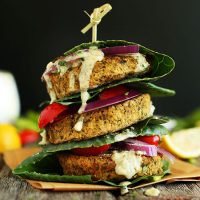 Stack of Baked Falafel Burgers with collard green leaves for a bun