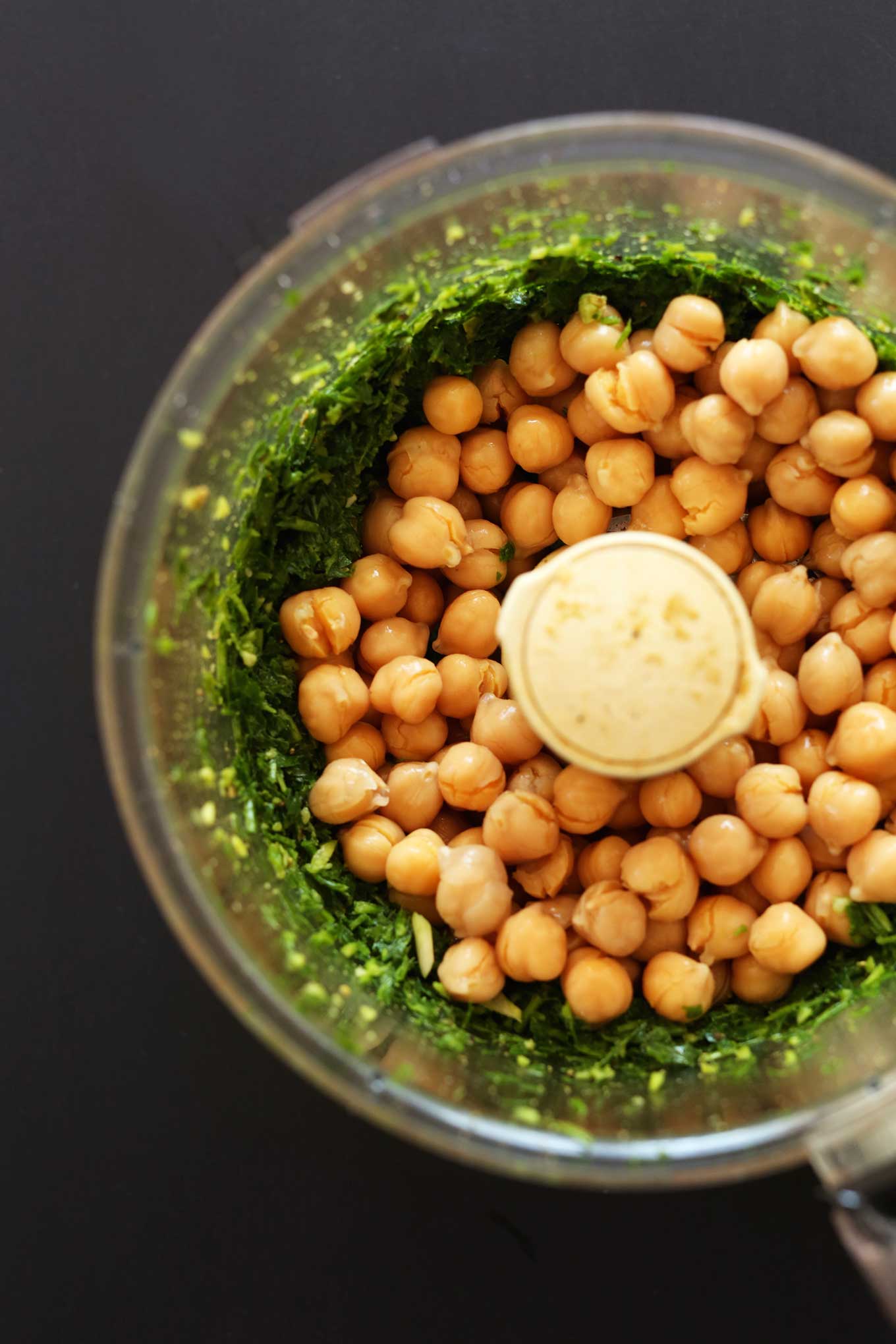 Chickpeas and greens in a food processor for making gluten-free vegan falafel