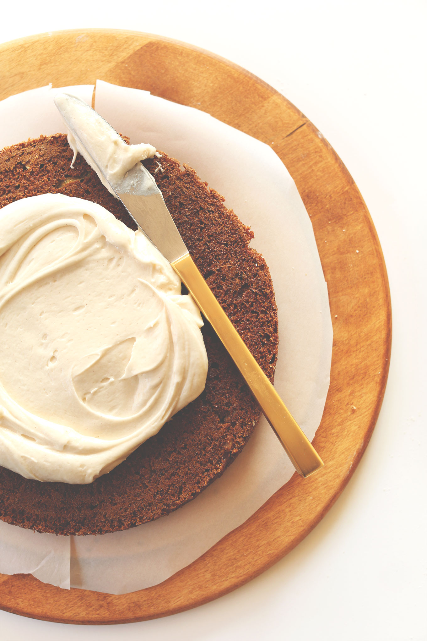 Spreading Vegan Cream Cheese Frosting over our Apple Gingerbread Cake