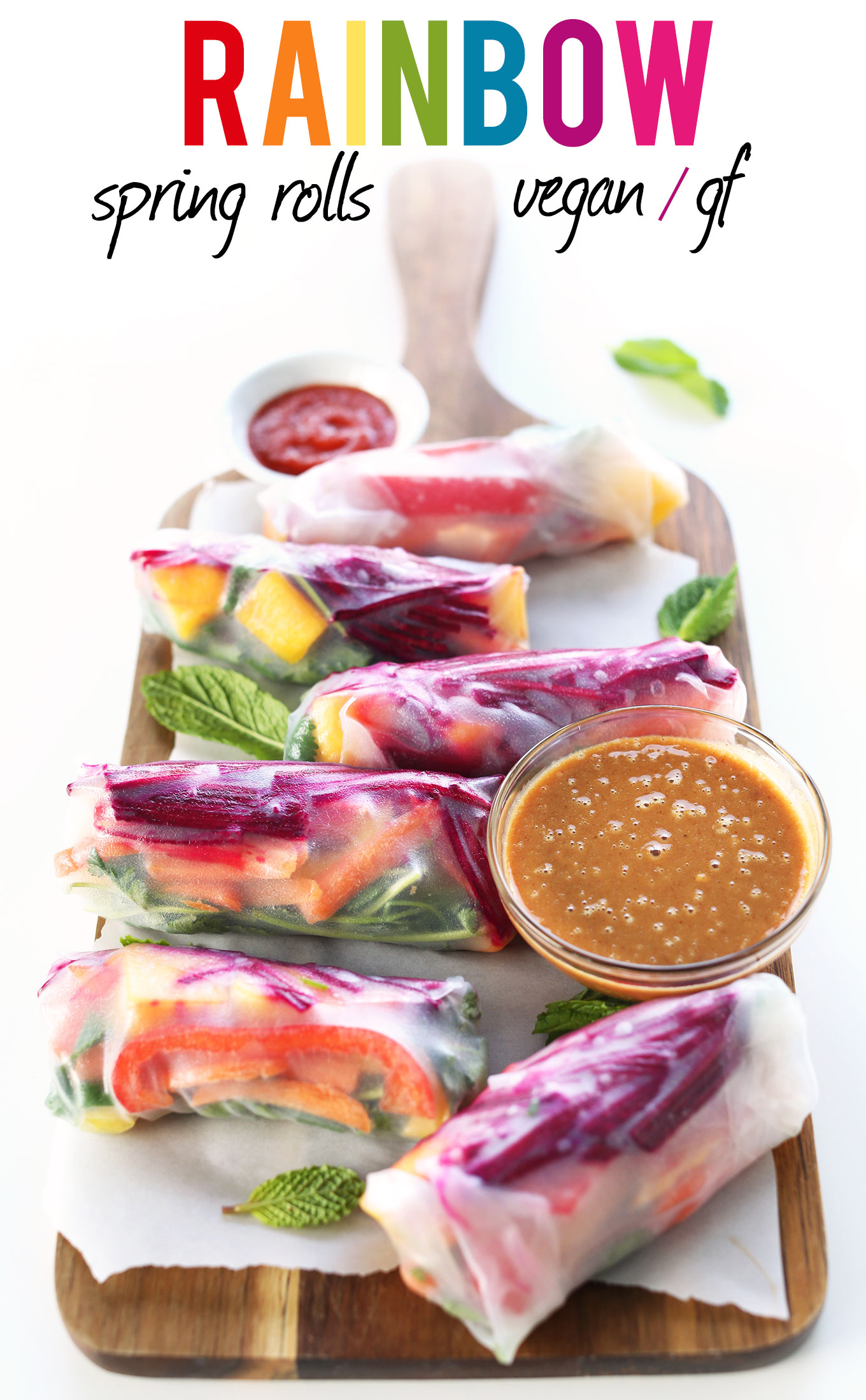 Homemade vegan Rainbow Spring Rolls with a bowl of Ginger Peanut dipping sauce