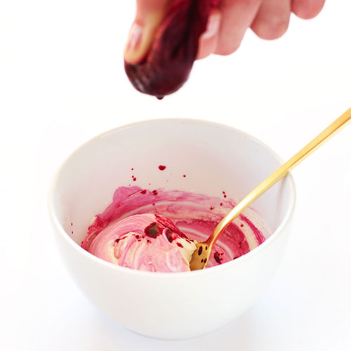 Squeeze beet juice into a bowl to make DIY natural food coloring