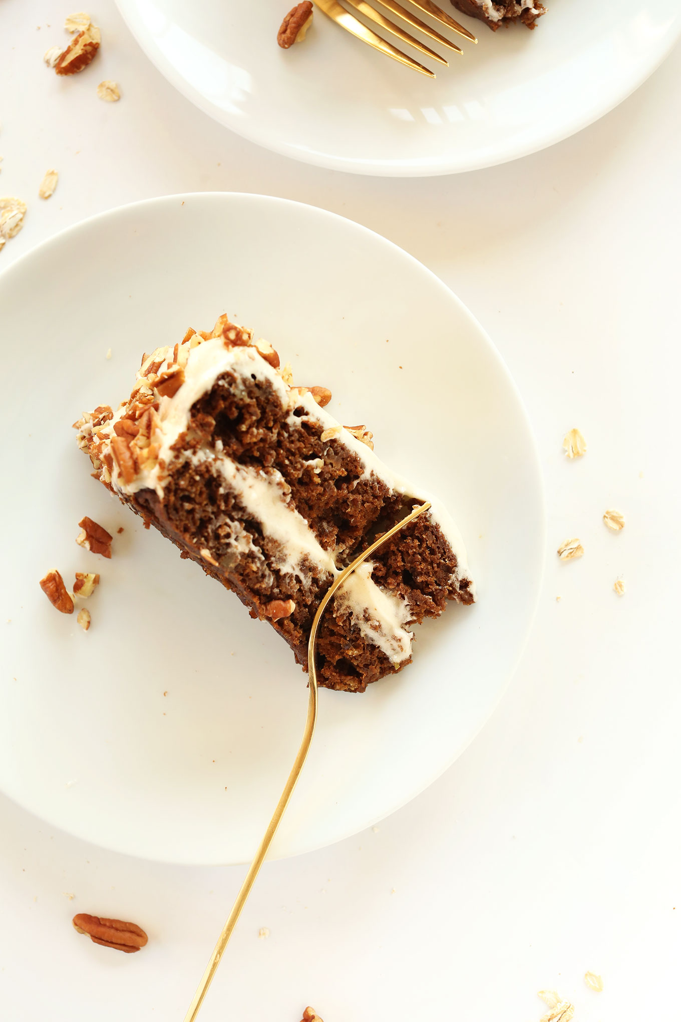 Using a fork to grab a bite of Apple Gingerbread Cake with Vegan Cream Cheese Frosting