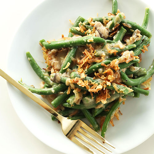 Plate of Creamy Vegan Green Bean Casserole topped with crispy onions