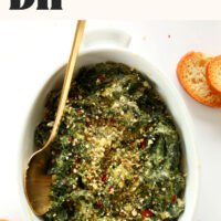 Overhead photo of a bowl of Creamy Kale and Spinach Dip that's perfect for holiday parties