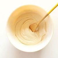 Stirring a bowl of our homemade Vegan Cream Cheese Frosting