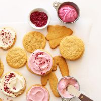 Assorted shapes of Vegan Sugar Cookies with pink and white frosting and sprinkles