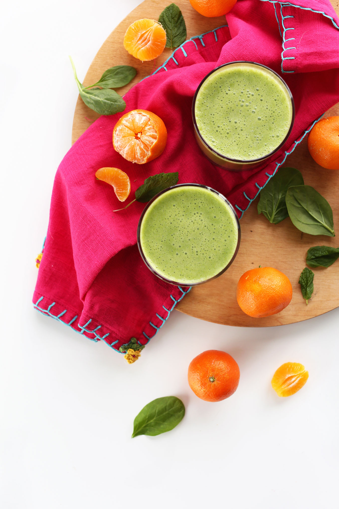 Glasses of our vegan green smoothie made with clementine, coconut, and spinach
