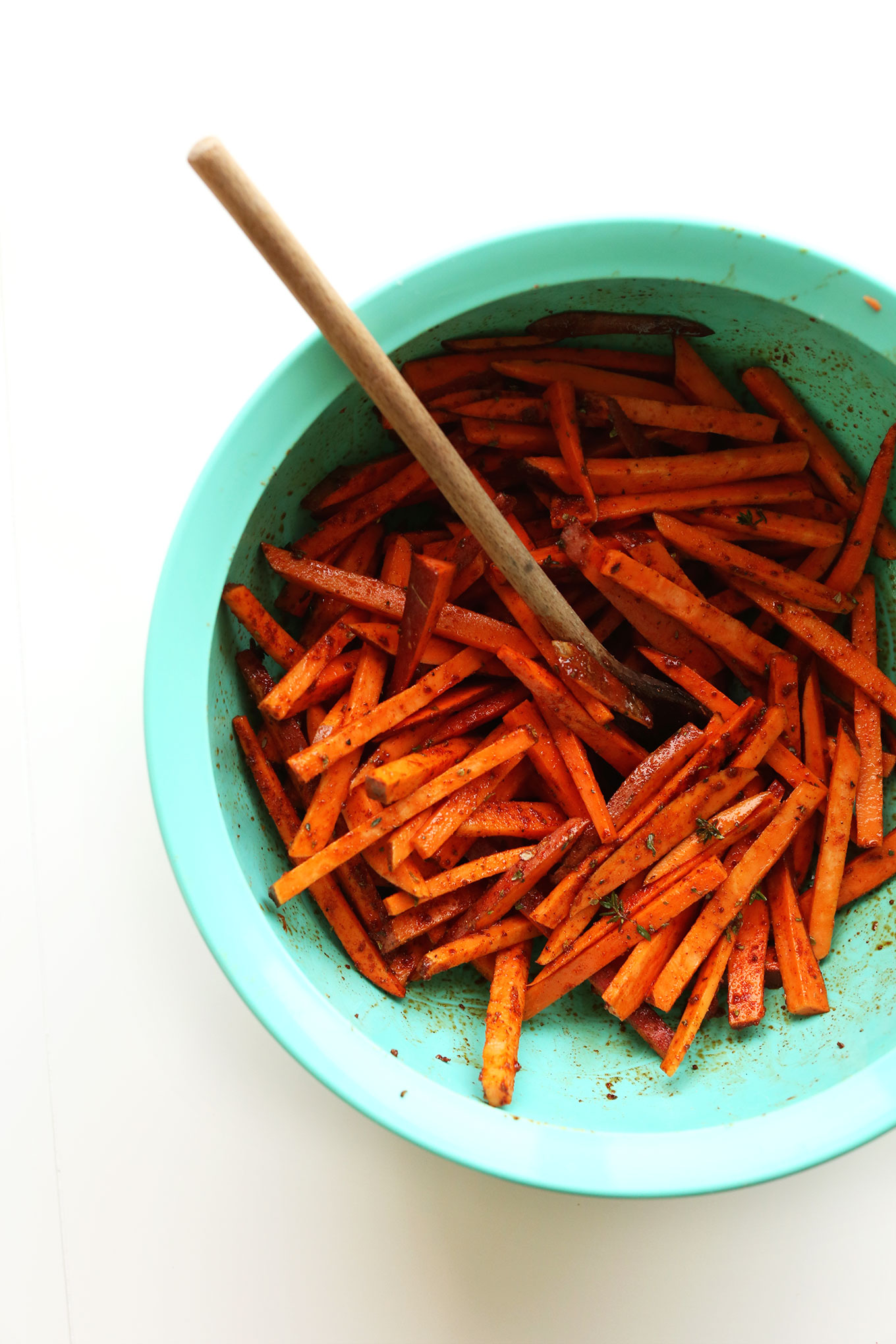 Mixing sweet potatoes and spices for our homemade Cajun Sweet Potato Fries recipe