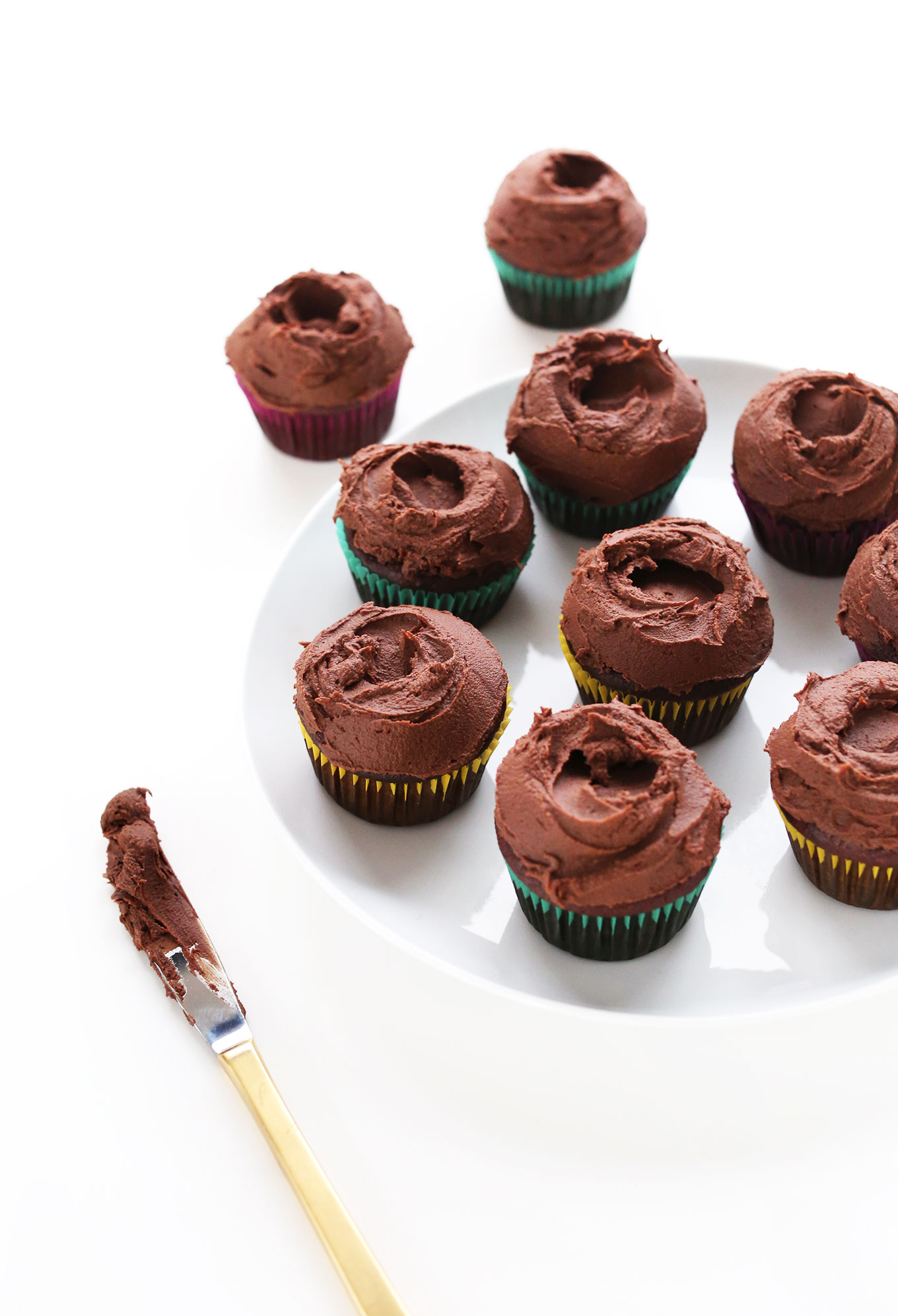 Plate of our fudgy vegan chocolate cupcakes with chocolate ganache frosting