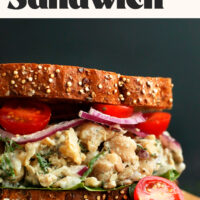 Vegan tuna salad sandwich made with whole grain bread, red onion, and tomatoes