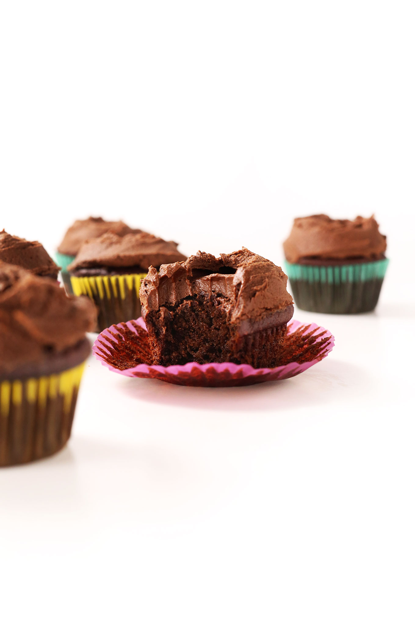 Vegan Gluten-Free Chocolate Cupcakes with yellow, pink, and turquoise wrappers