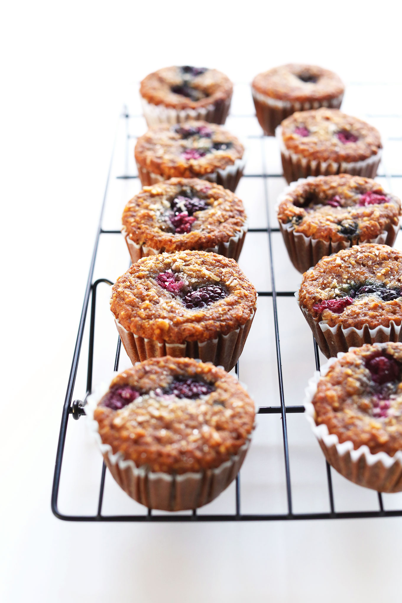 Batch of Vegan Gluten-Free Berry Coconut Muffins on a cooling rack