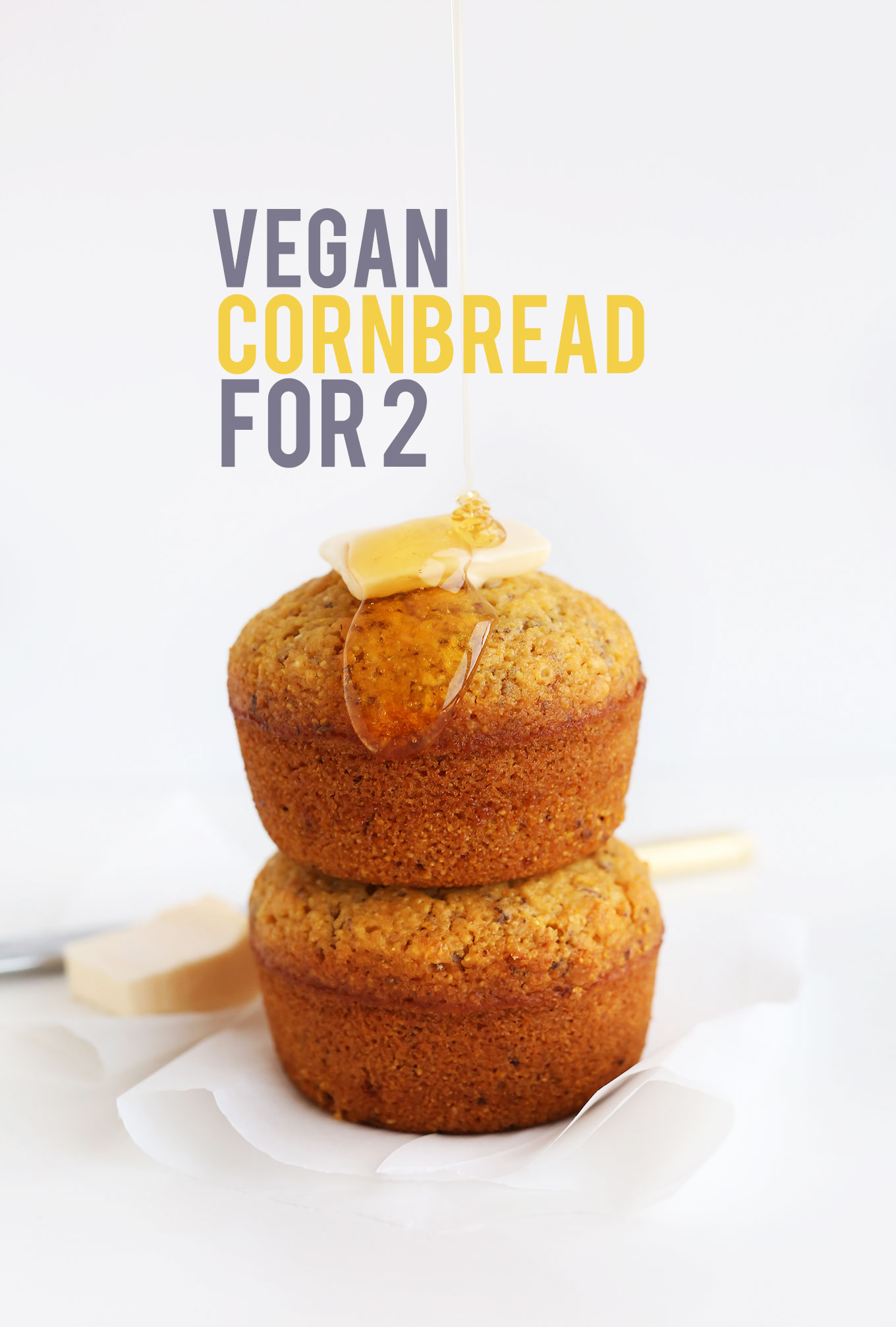 Stack of two Vegan Cornbread Muffins drizzled with agave