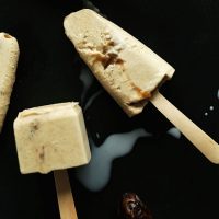 Baking sheet with Creamy Dulce de Leche Pops on wooden popsicle sticks